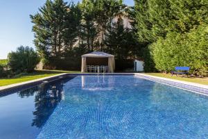 a swimming pool with a gazebo in a yard at The Seafront Manor by The Getaway Collection in Cascais