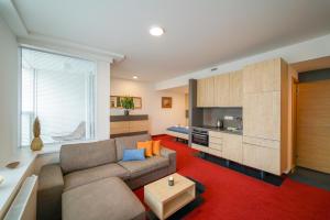 a living room with a couch and a kitchen at Zora Exclusive Apartment in Bratislava