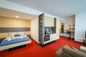 a bedroom with a bed and a living room at Zora Exclusive Apartments by CHORS in Bratislava +85 photos