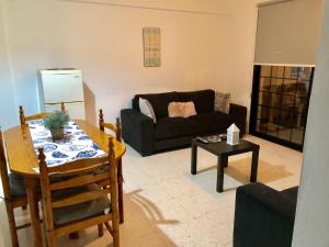 a living room filled with furniture and a fireplace at Angela Holiday Apartments in Paphos City