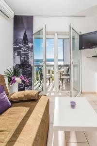 a living room with a couch and a view of a city at Villa Mara in Crikvenica