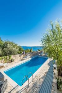 a swimming pool with a view of the ocean at Villa Mara in Crikvenica