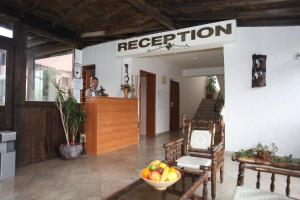 a reception room with a bowl of fruit on a table at Hotel Laguna in Lozenets