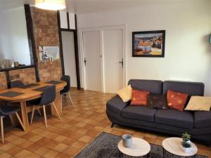 a living room with a couch and a table at Gîte altzia haut in Saint-Michel