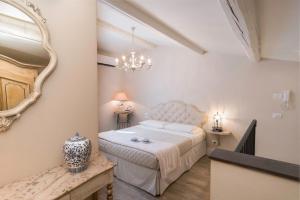 a bedroom with a bed and a mirror on the wall at Pistoia Luxury Suite in Pistoia