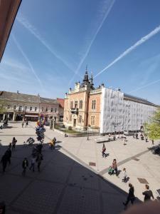 a group of people in a courtyard in front of a building at Lux A28 in Novi Sad