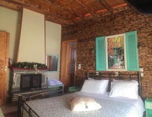 a bedroom with a bed and a fireplace at Mathes in Kl&aacute;vsion