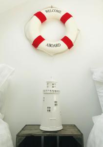 a lifebuoy and a white lighthouse next to a life preserver at Nancie's Place - - A BEAUTIFUL GEORGIAN DUPLEX APARTMENT - - Centre of Old Dartmouth Town - - ONSITE PRIVATE PARKING in Dartmouth +23 photos
