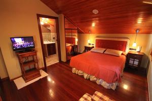 a bedroom with a bed and a flat screen tv at Casa Suarna in Navia de Suarna