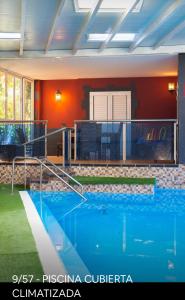 a large swimming pool in a building with red walls at Casa Roque Aguayro in Agüimes