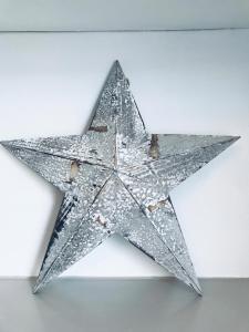 a silver star hanging on a wall at Nancie's Place - - A BEAUTIFUL GEORGIAN DUPLEX APARTMENT - - Centre of Old Dartmouth Town - - ONSITE PRIVATE PARKING in Dartmouth