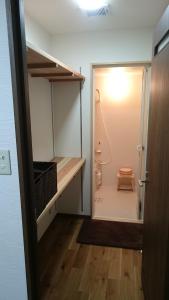 a bathroom with a closet with a toilet in it at Aki Kokubunji Shukubou in Higashihiroshima