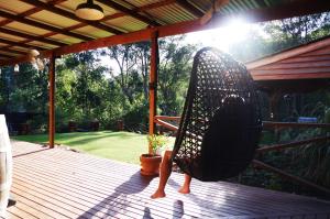 una mecedora sentada en una terraza de madera en Nannup Bush Retreat, en Nannup