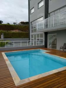 a large swimming pool in front of a building at Domus Angelis in Cachoeira Paulista