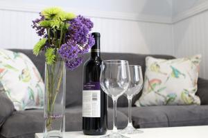 a bottle of wine and two wine glasses on a table at Sweet Dreams B&B LA in Sherman Oaks