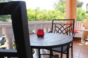 un vase rouge assis sur une table sur un balcon dans l'établissement Sweet Dreams B&B LA, à Sherman Oaks