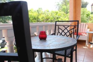 a red vase sitting on a table on a balcony at Sweet Dreams B&B LA in Sherman Oaks