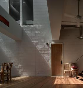 a room with a staircase and two chairs and a table at Lantern Hotel in Kuala Lumpur