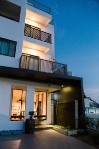 a large white building with a balcony on it at Easy Life B&B in Taitung City