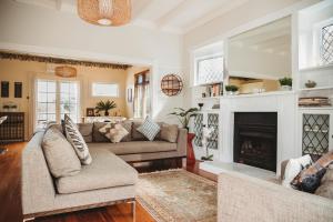 a living room with a couch and a fireplace at Island Villa- Waiheke Escapes in Oneroa