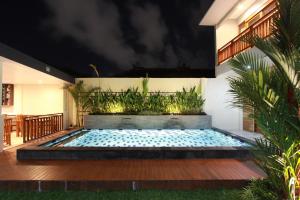 a swimming pool in the middle of a house at Praba Guesthouse in Kuta