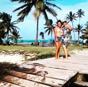 a man and a woman standing on a beach at POSADA MISS MATY BATISTA in San Andrés