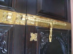 a wooden door with a gold door handle on it at Riad Jnane Mogador in Marrakesh