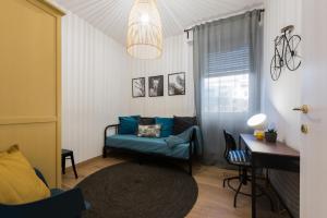 a living room with a blue couch and a table at B&B La Marmora 39 in Florence