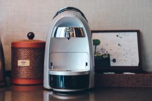 a small appliance sitting on a table next to a cup at Hard Rock Hotel Desaru Coast in Desaru
