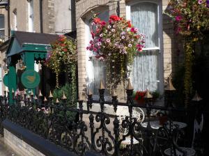 una valla con flores al lado de un edificio en The Farthings, en York