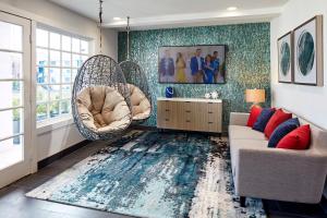 a living room with two chairs and a rug at The Shoal Hotel La Jolla Beach in San Diego
