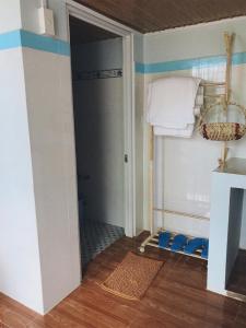 a bathroom with a closet with blue and white walls at Pun corner homestay in Con Dao