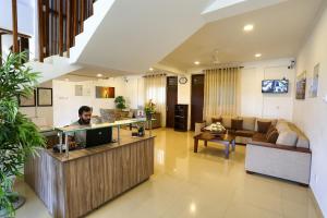 a man sitting at a counter in a living room at Shamaz Galle in Galle