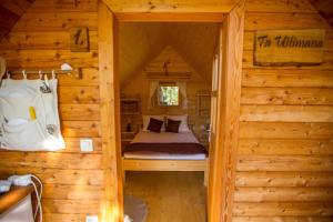 a bedroom in a log cabin with a bed in it at Glamping Organic Farm Slibar in Tržič