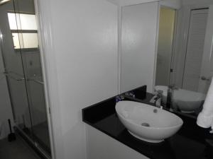 a bathroom with a white sink and a mirror at Foxrun Retreat - 3BR Inverness Poolhome in Inverness +7 photos