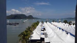 a row of white boats parked next to the water at Geopark Hotel Kuah Langkawi in Kuah