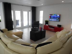 a living room with a couch and a flat screen tv at Foxrun Retreat - 3BR Inverness Poolhome in Inverness