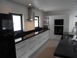 a kitchen with white cabinets and a black counter top at Foxrun Retreat - 3BR Inverness Poolhome in Inverness