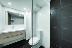 
a bathroom with a toilet a sink and a bathtub at Central Studio Hotel Sydney in Sydney
