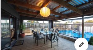 a patio with a table and chairs and a pool at Skyline SkyRides Premium Property, see host info for pets in Rotorua