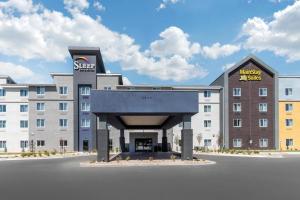 a large hotel with a sign on the front of it at Sleep Inn & Suites Denver International Airport in Denver