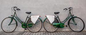 two green bikes parked next to a wall at Horizon Blu Boutique Hotel in Kalamata