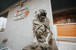 a statue of a lion on the side of a building at Hotel Wine Palace in Tbilisi City
