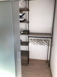 a walk in closet with black shelves and shoes at JOE LUXURY HOUSE in Turin