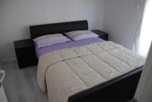 a bedroom with a large bed with two pillows at Room near the center in Split