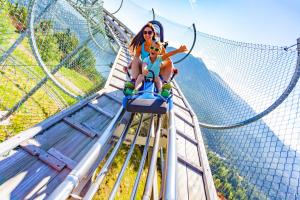 a woman and a child on a roller coaster at Schlosshotel Seewirt in Turracher Hohe