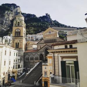 a view of a city with a clock tower at Zia Pupetta Suites in Amalfi