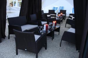a group of chairs and tables with candles on them at Villa Mar Bella in Costinesti