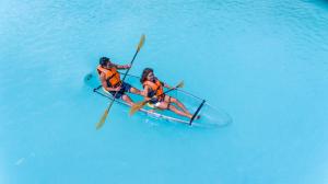two people are in a kayak in the water at Solea Mactan Resort and Waterpark in Mactan