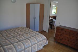 a bedroom with a bed and a dresser and a piano at Holiday Villa Palanga in Palanga